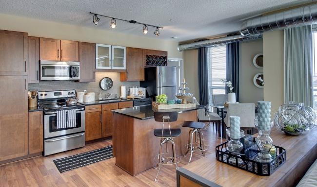 a kitchen with a bar stool and a table