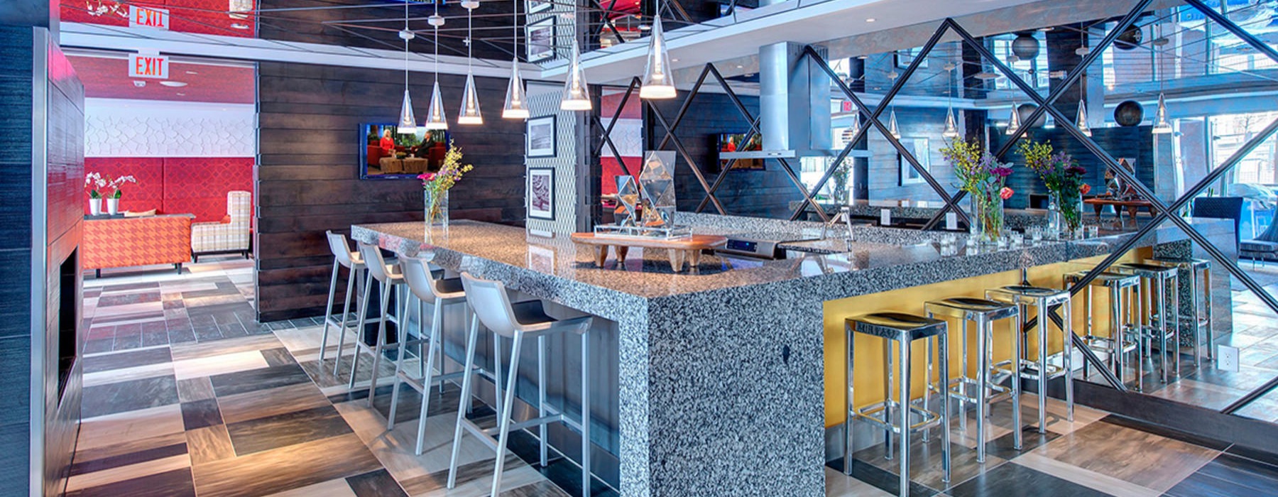 a community kitchen with a bar and chairs