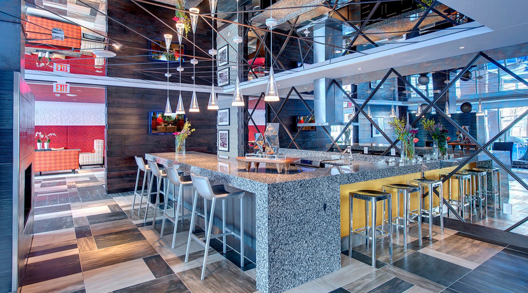 a clubroom kitchen with a bar and chairs