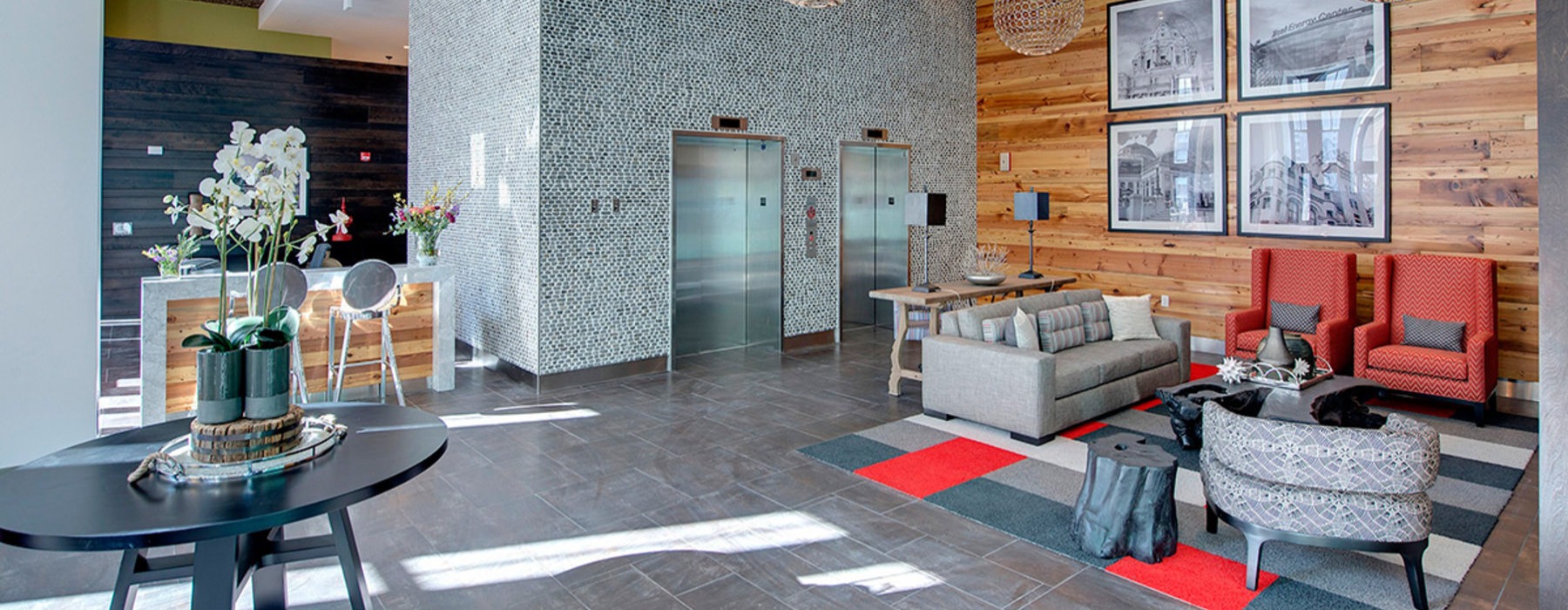 a lounge with tables, chairs and a couch