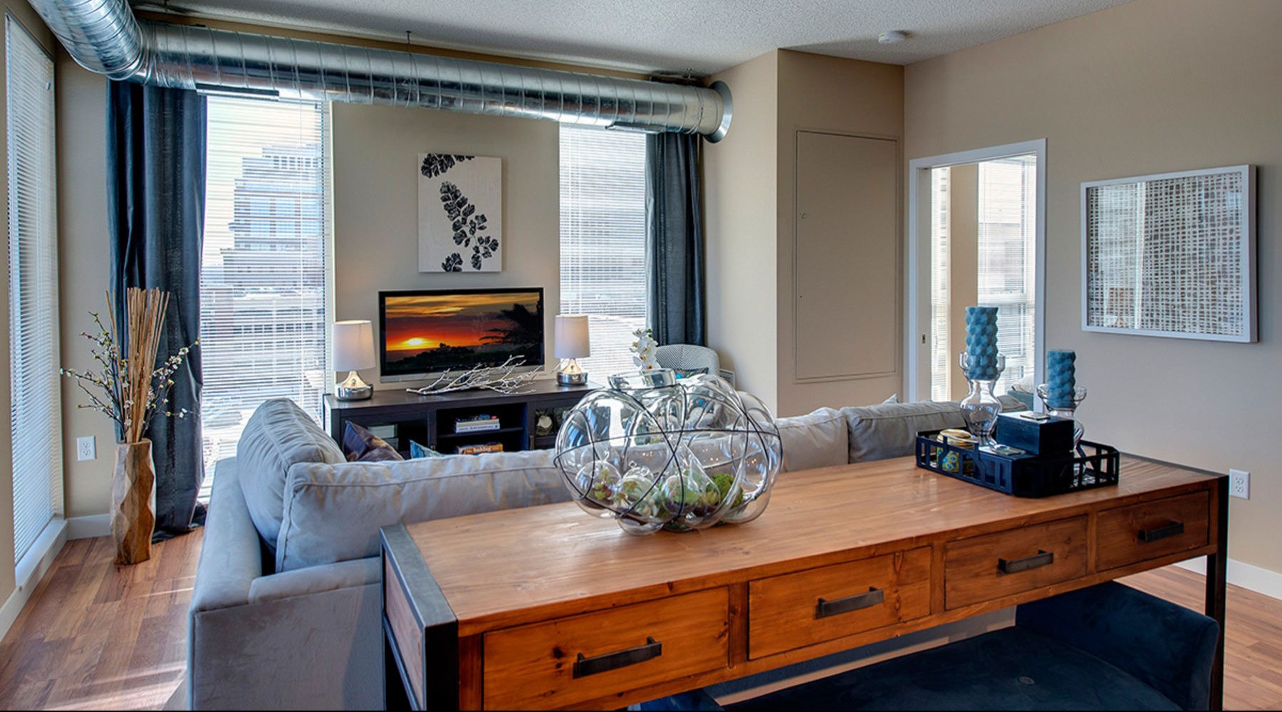 a living room with a tv, couch and a table